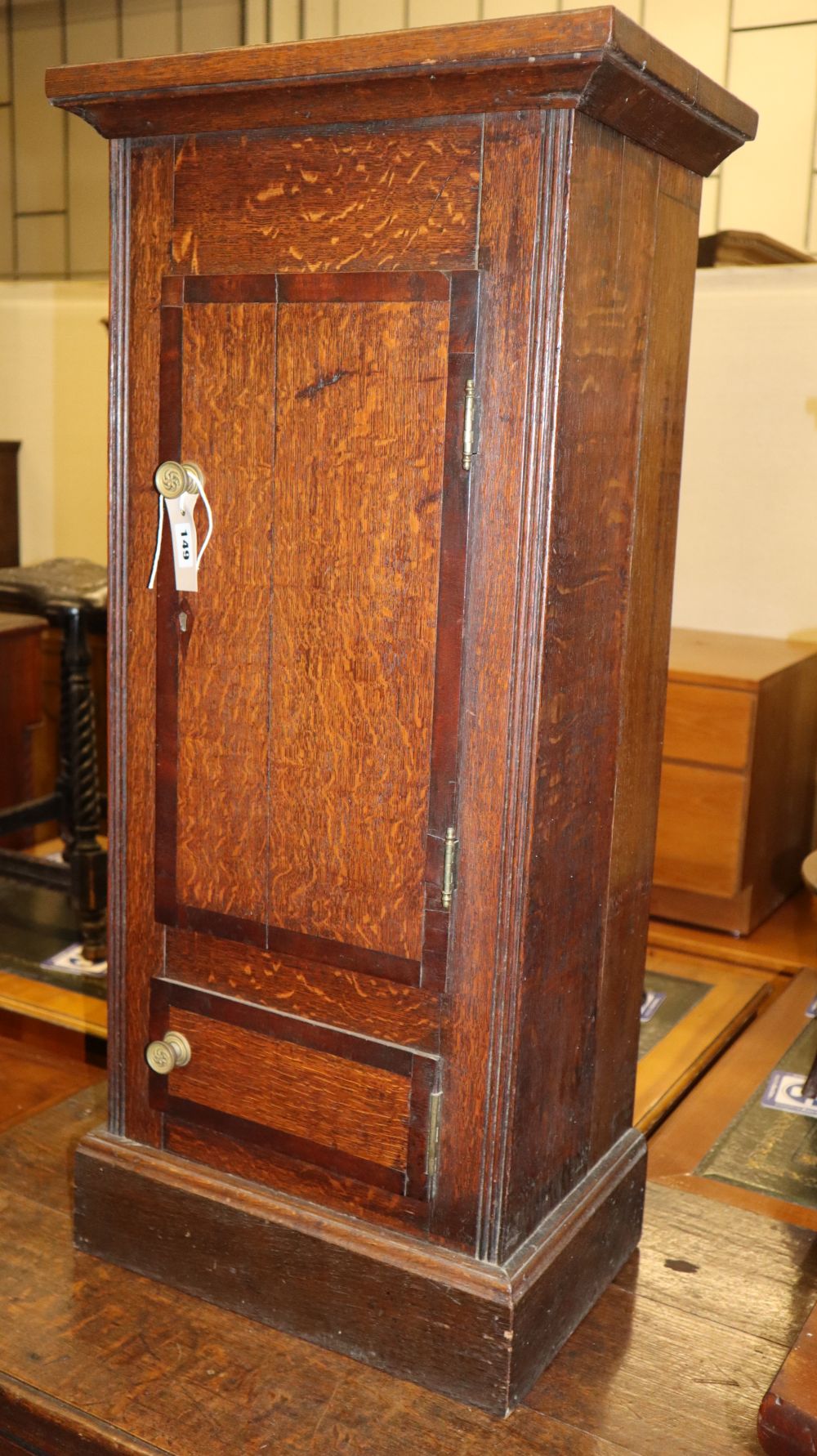 A 19th century mahogany banded oak pedestal bedside cupboard (converted from a longcase clock case) W.42cm, D.29cm, H.92cm